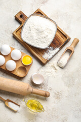 Ingredients for baking and wooden rolling pin on light background