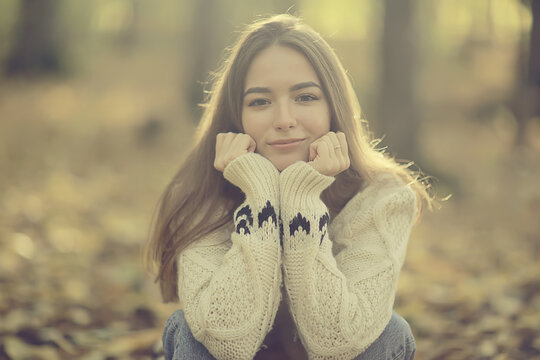 girl sitting autumn park, autumn season september in the forest