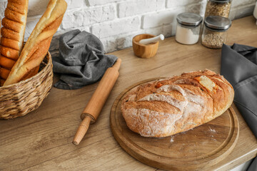 Counter with fresh bread near white brick wall