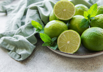 Green  Limes with fresh mint leaves on  plate