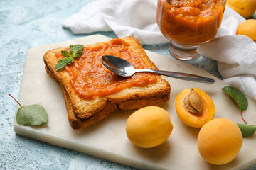 Board of tasty sandwich with apricot jam on table, closeup