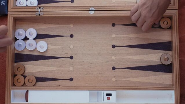 man and woman playing backgammon and rolling dice.4K