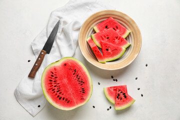 Plate with slices of watermelon, knife and napkin on white background