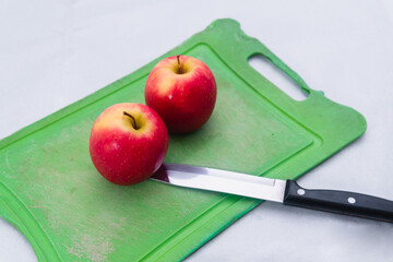 High quality photography. A pair of red apples on an isolated white background. Apples on a cutting board with a knife.