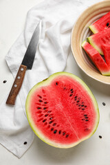 Plate with slices of watermelon, knife and napkin on white background