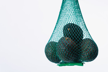 High quality photography. A bag full of avocados on an isolated white background.