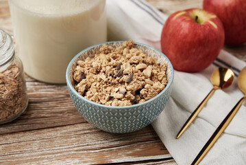 Granola with milk in blue bowl on wooden table, Healthy organic breakfast with muesli, Food clean eating concept