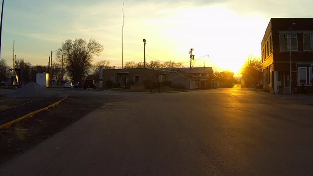Point Of View Of Street Amidst Buildings In City Against Sky At Sunset - Buckner, Missouri