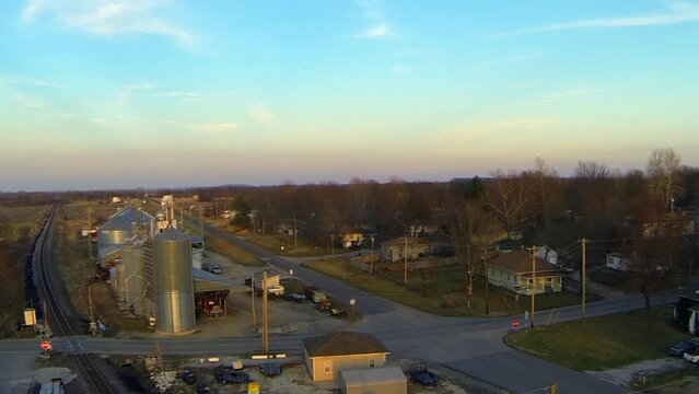 Aerial Upward Shot Of Houses And Industries Against Sky During Sunset - Buckner, Missouri