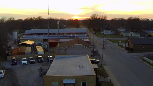 Aerial Upward Shot Of Buildings And Houses By Street In City During Sunset - Buckner, Missouri
