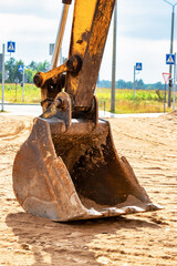 Fototapeta premium Close up of excavator bucket at construction site. Construction equipment for earthworks.