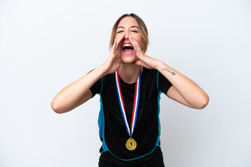 Young caucasian woman with medals isolated on white background shouting and announcing something