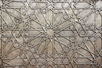 Detail of metal door with traditional islamic ornament. Copper shutter with antique and national moroccan floral pattern - obrazy, fototapety, plakaty
