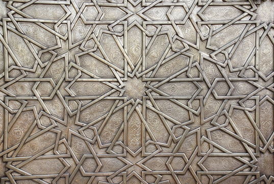 Detail of metal door with traditional islamic ornament. Copper shutter with antique and national moroccan floral pattern