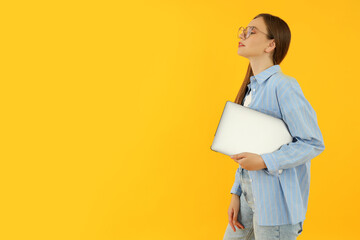 Concept of people, young woman on yellow background