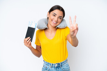 Woman with Inflatable Travel Pillow over isolated background smiling and showing victory sign