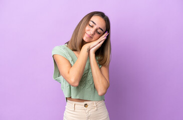 Young caucasian woman isolated on purple background making sleep gesture in dorable expression