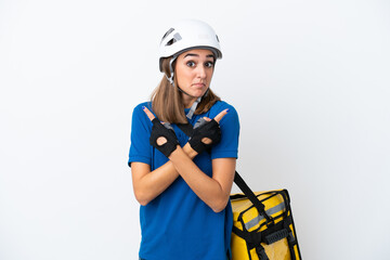 Young caucasian woman with thermal backpack isolated on white background pointing to the laterals having doubts