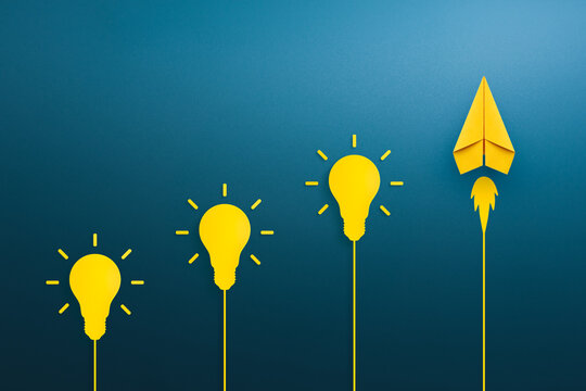 Yellow light bulb and paper plane, Success in business growth, innovation and idea concept