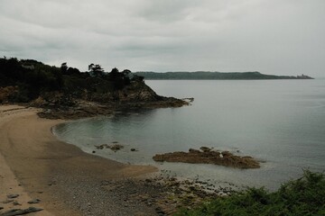 Breathtaking view of the Normandy coastline under a cloudy sky on a gloomy day, France.