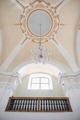 Vertical of a dome ceiling with a chandelier in a church.