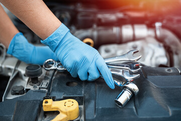 Male mechanic help woman solve the problem of car breakdown.