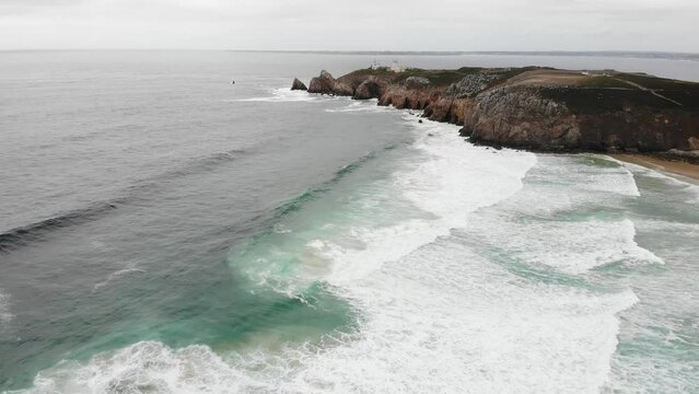 Coastline with promontory Pointe du Raz and sandy beach in Crozon peninsula, Brittany, France.