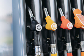 petrol pump filling fuel nozzles at gas station