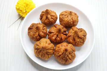Fried Modak. It's a traditional sweet dish of coconut, jaggery, and dry fruits stuffed inside the wheat dough. Offered to Lord Ganesha during the Ganpati Chaturthi festival in India. with copy space.