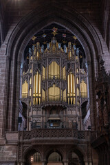 close-up view of the church organ and pipes in the central nave of the historic Chester Cathedral in Cheshire