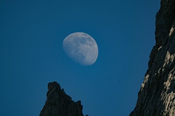 Rocky cliff with the fading moon in the background