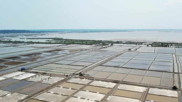 Aerial view of people working in salt fields