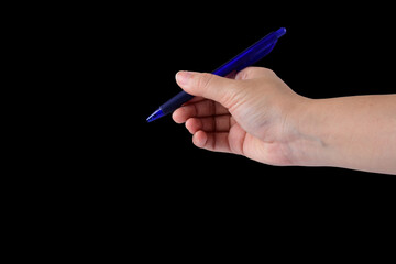 hand holding pen isolated on black background