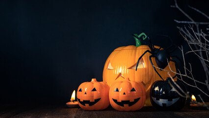 Halloween pumpkin head jack with burning candles in scary deep night, space for text. Halloween decor