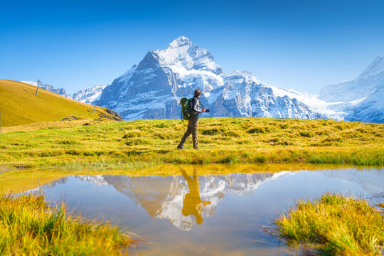 Tourist with a backpack in the mountains. Mountain hiking in the high mountains. Travel and adventure. Active life. Landscape in the summertime.