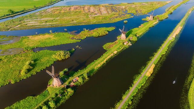 An aerial view of the windmill. Kinderdijk national park. Canals with water for agriculture. Fields and meadows. Landscape from the air.