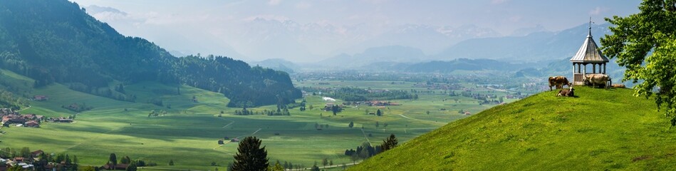 Panoiramic view of white arbor on a hill against the background of the rural area and mountains