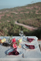 Table set with linen tablecloth and napkins for feast of Rosh Hashana, new Jewish year start , with traditional symbolic dishes and foods, pomegranate, Honey, Apple and wine. 