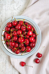 Bright fresh red berries on a light linen background. Flat lay. Summer food. Healthy fruit. Vegan food. Eco farming and gardening as a hobby. Diet, health care, wellbeing. Agricultural business.