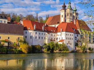 Fototapeta na wymiar A beautiful view from the water of the St. Michael Cathedral in the city of Steyr, Upper Austria