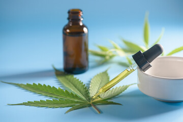cannabis essential oil container with cannabis leaves and cannabis seeds