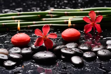 Wandcirkels tuinposter Still life of with two red orchid , and zen black stones with bamboo grove on wet background  © Mee Ting