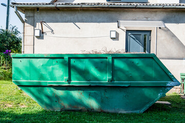 Fototapeta na wymiar Large metal waste container for construction debris