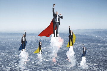 European businessmen and women heroes with cape flying on abstract city background. Success,...