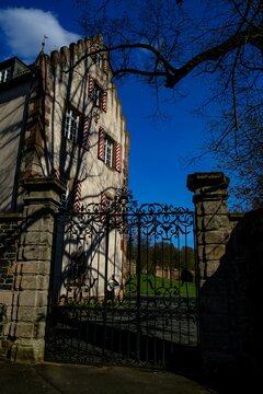 Vertical shot of a Ramholz castle with a gate and sky in the background
