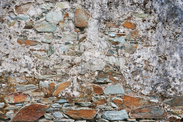 Simple textured light background of stone wall of aged building