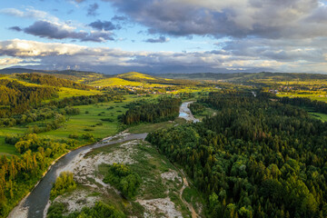 Bialka River in Podhale region, High tatras mountains in Poland at sunset. Drone View