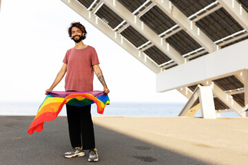 Happy man with a pride flag. LGBT community..