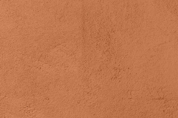 Saturated pastel brown colored low contrast Concrete textured background. Empty colourful wall texture with copy space for text overlay and mockups. 2023, 2024 color trend