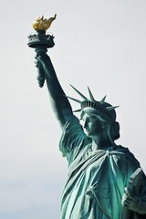 Famous statue of Liberty against the blue sky in New York © Dejan Dajković/Wirestock Creators